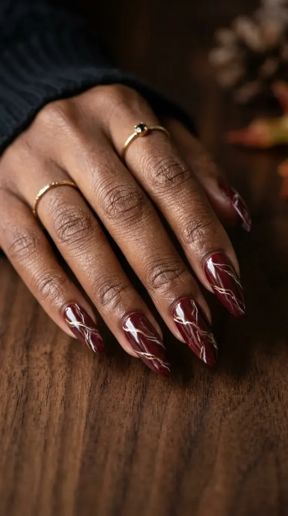 Burgundy Marble Almond Nails With Gold Veining