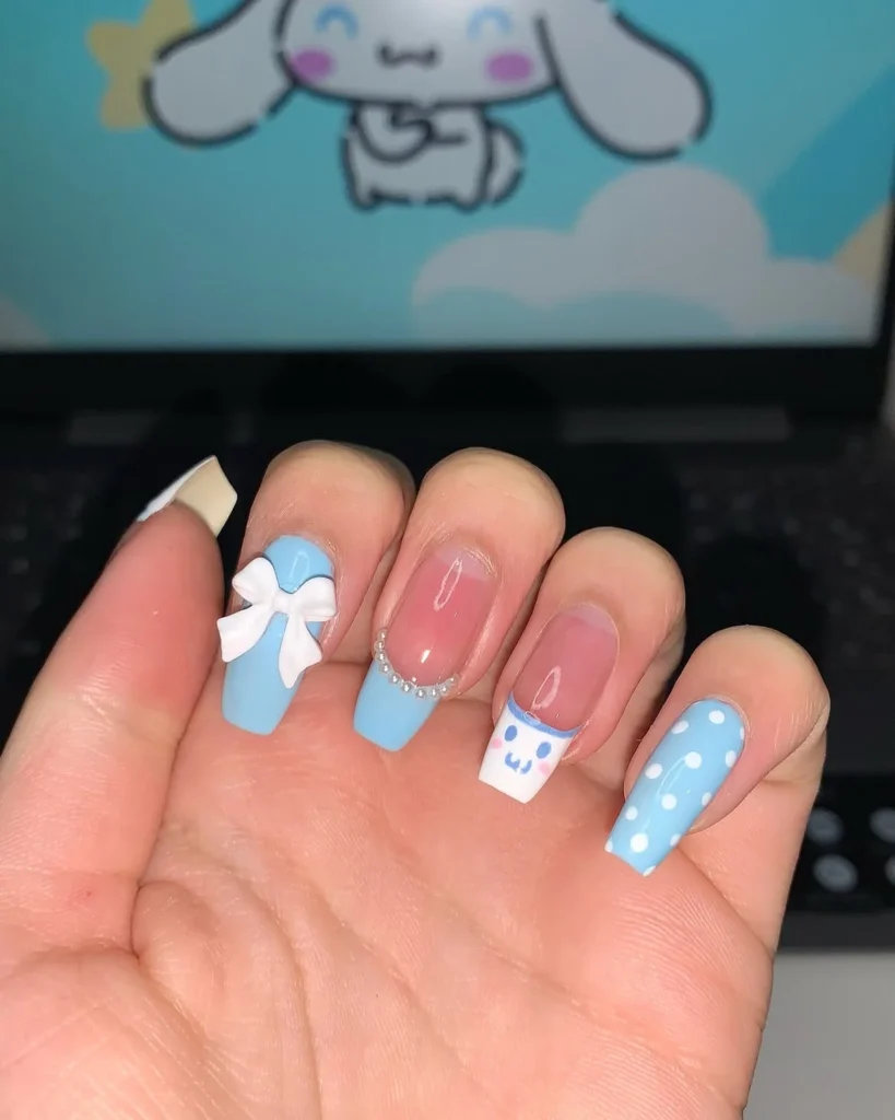 Baby blue Cinnamoroll Sanrio nails with a white 3D bow, beaded French tip, Cinnamoroll face, and polka dots on long square nails