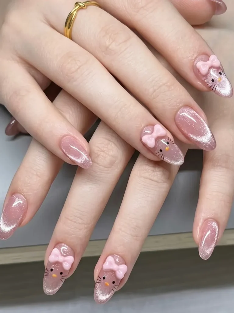 Pink Hello Kitty nails with a cat eye glitter finish, minimal whisker line art, and pale pink 3D bows on almond nails