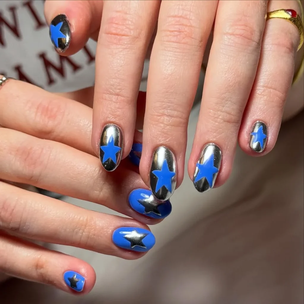 Cool girl nail designs with silver chrome and electric blue base and star cutouts on short round nails