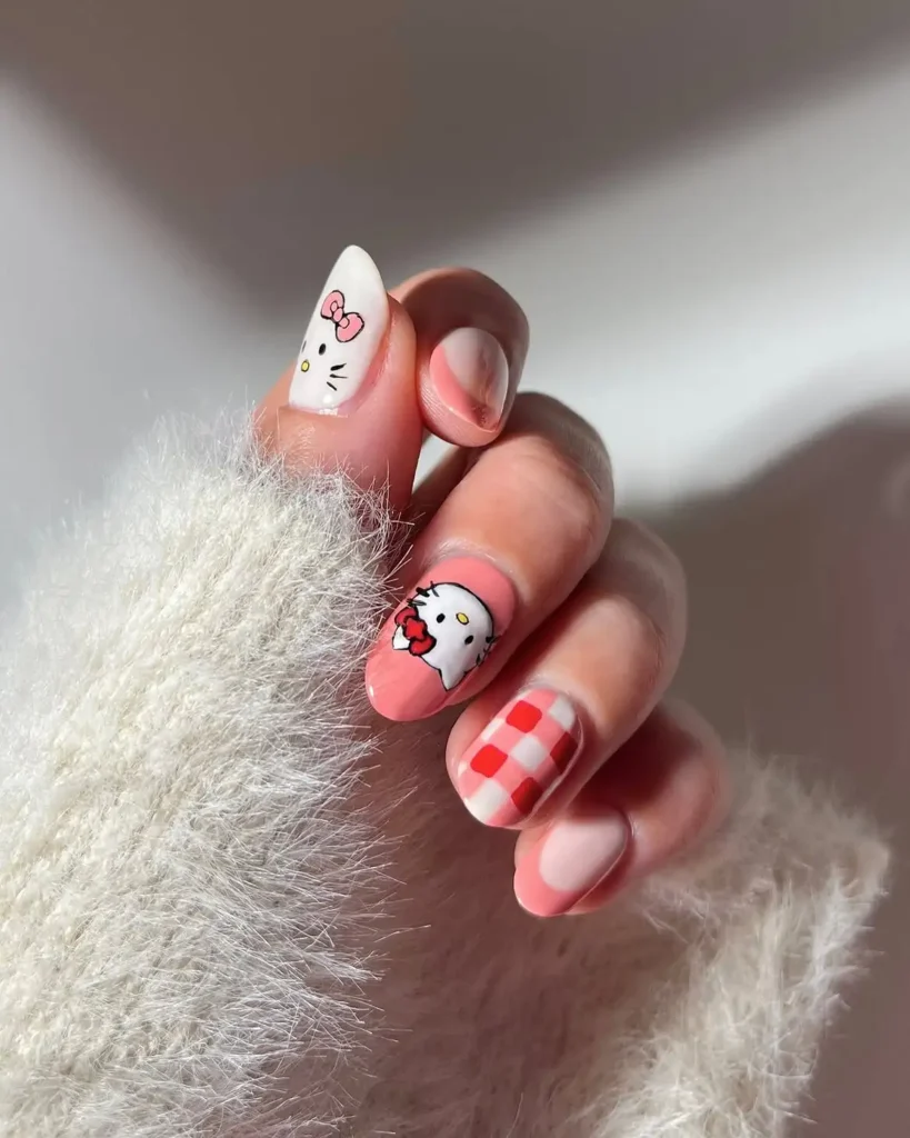 Peachy pink short Hello Kitty nails with a white Kitty face tip, Kitty holding a flower, and pink gingham on round natural-length nails