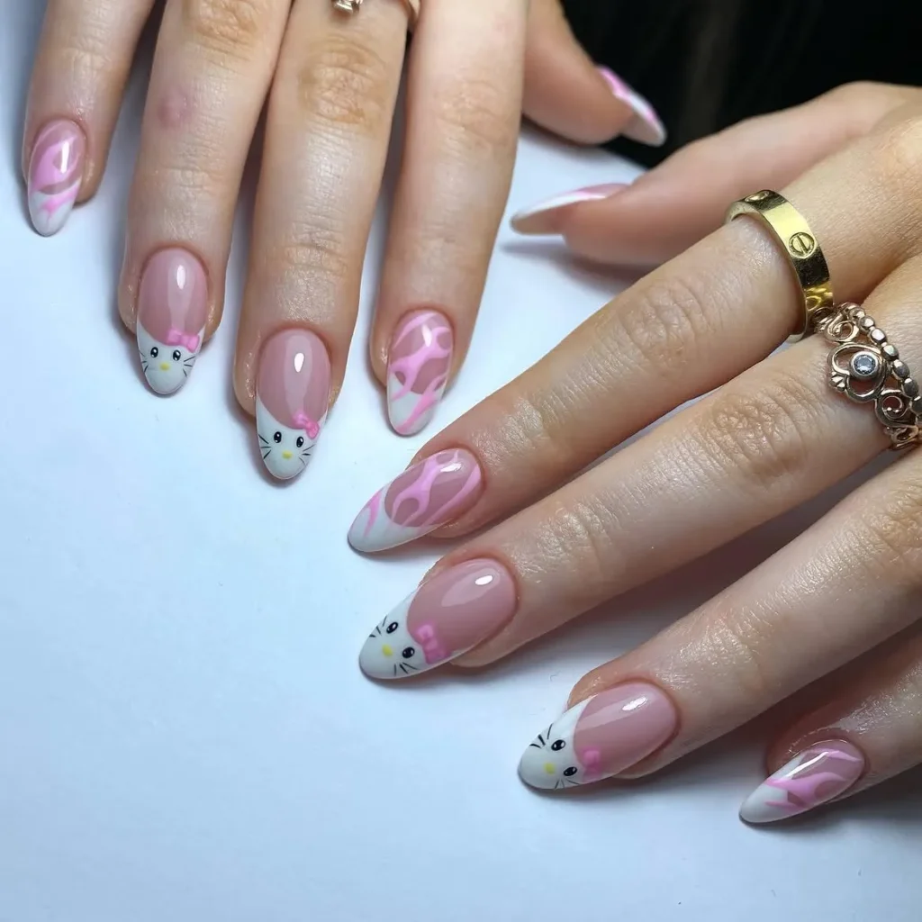 Y2K pink flame French Hello Kitty nails with Kitty face tips, tiny pink bows, and flame print on a nude almond base