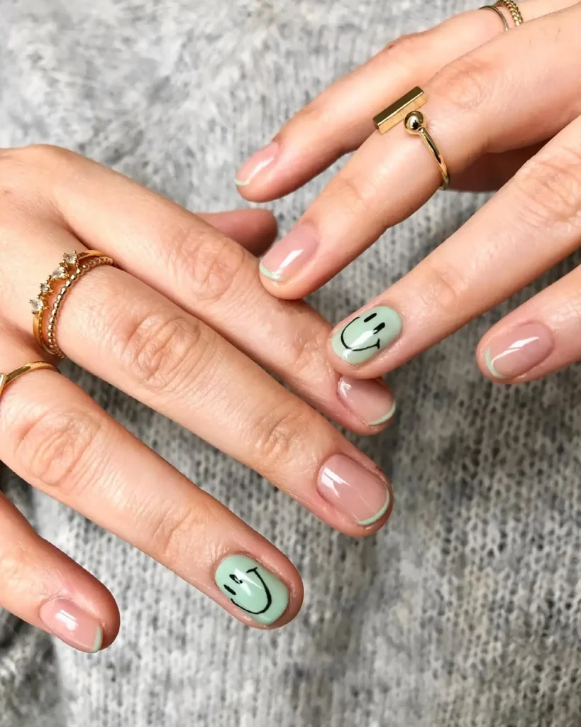 Summer smiley face nails with pistachio green micro French tips and mint smiley accent nails on short natural nails