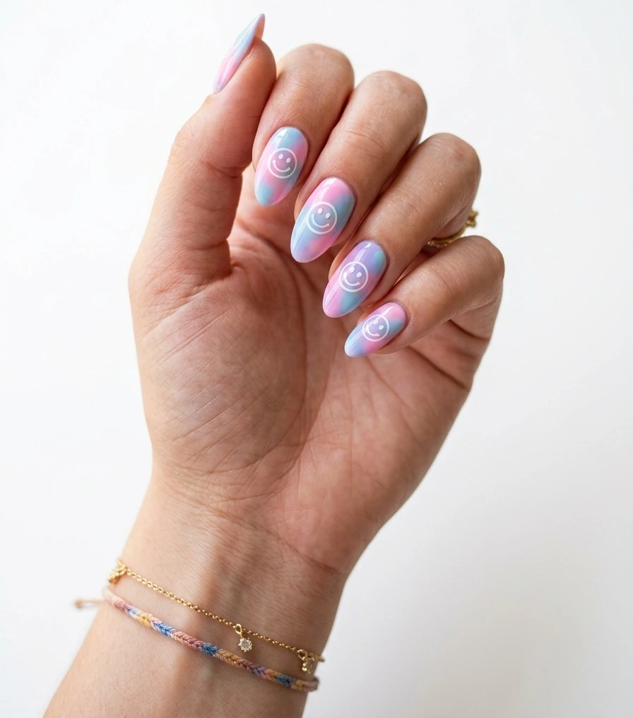 Summer smiley face nails with pastel tie-dye base and white-outlined floating smiley faces on medium almond nails